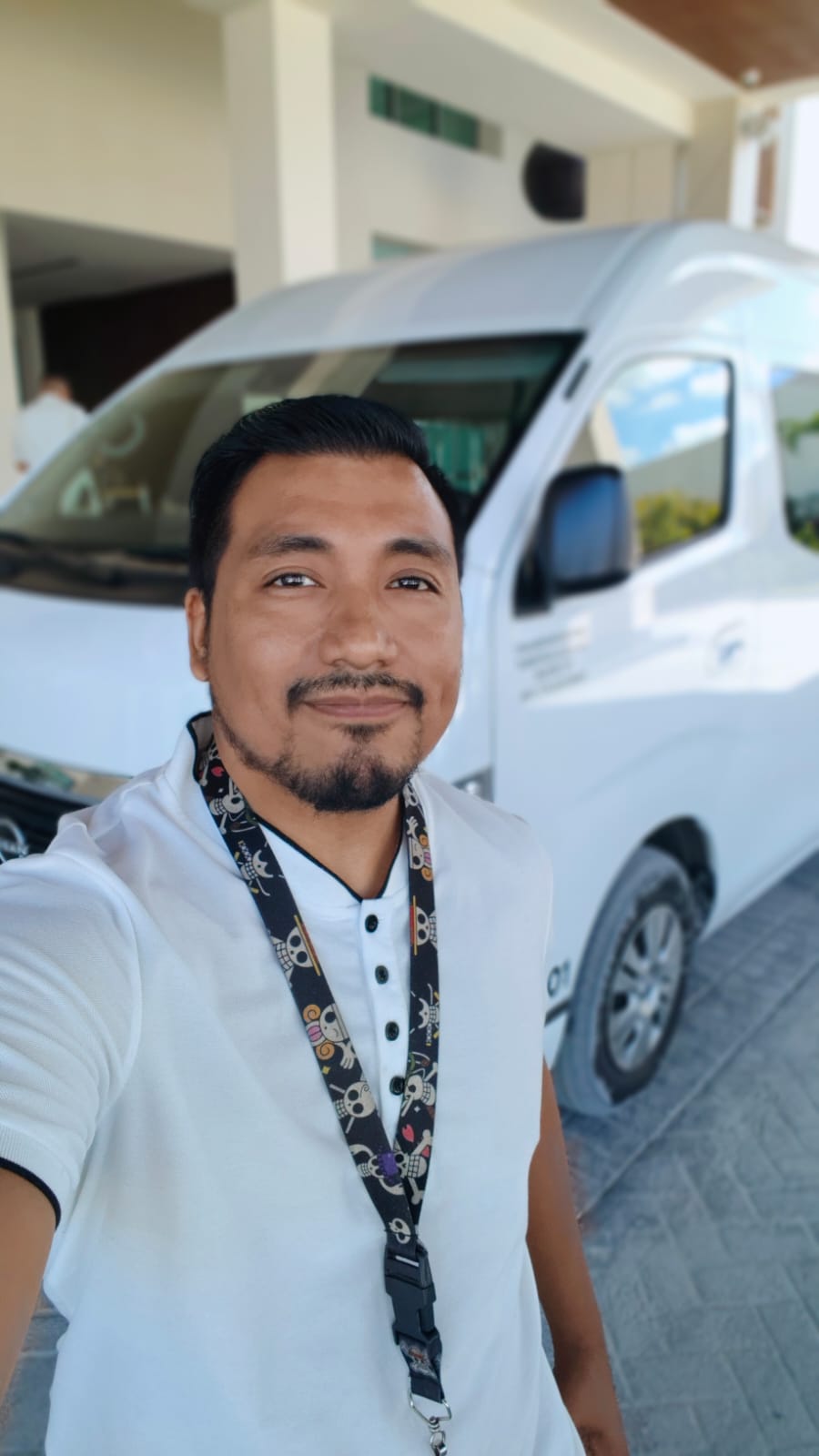 Oscar holding a welcome sign at the airport